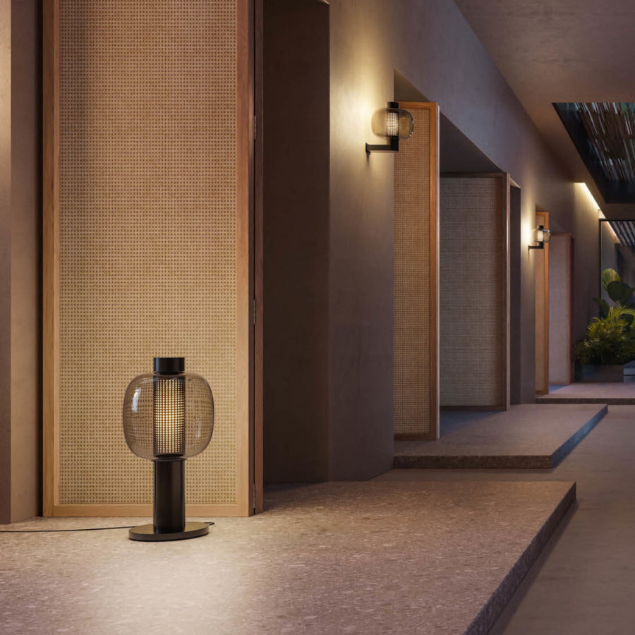 Modern interior design with a textured wall, bonbori floor lamp, and architectural elements.