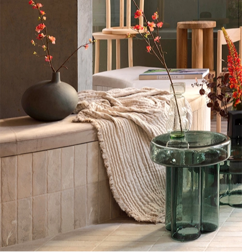 Soda side table in petrol green near flower and blanket design