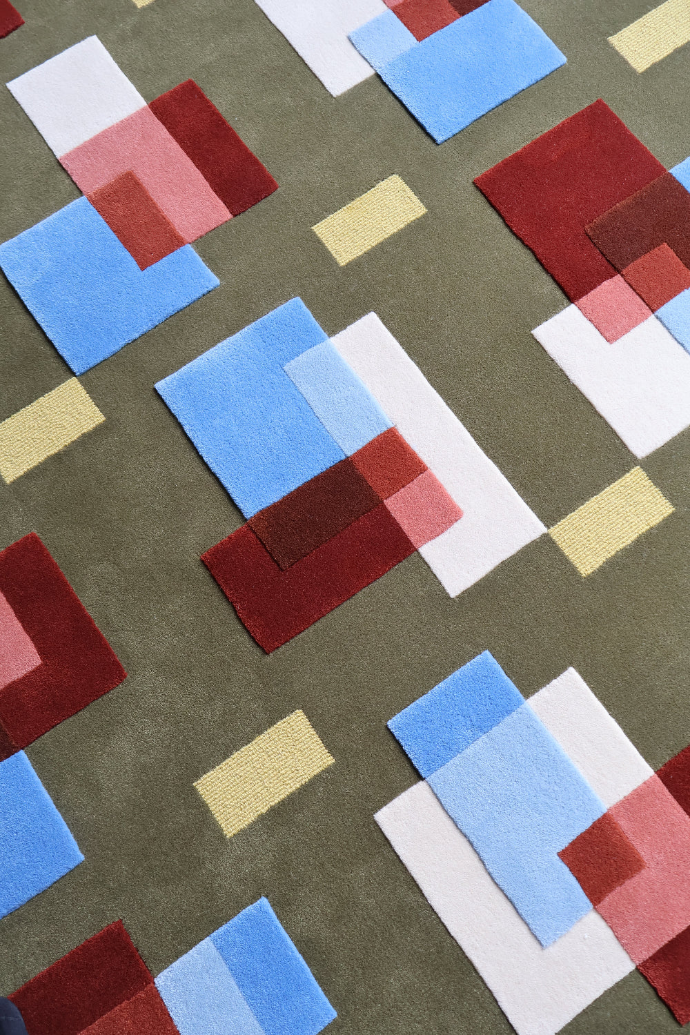 Pattern of geometric shapes in red, blue, and white on a brown background