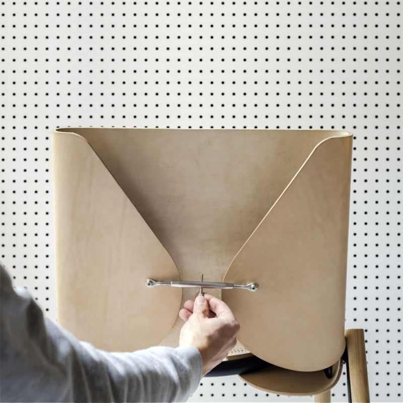 Tightening the joint of 1085 Edition Leather Chair by Kristalia