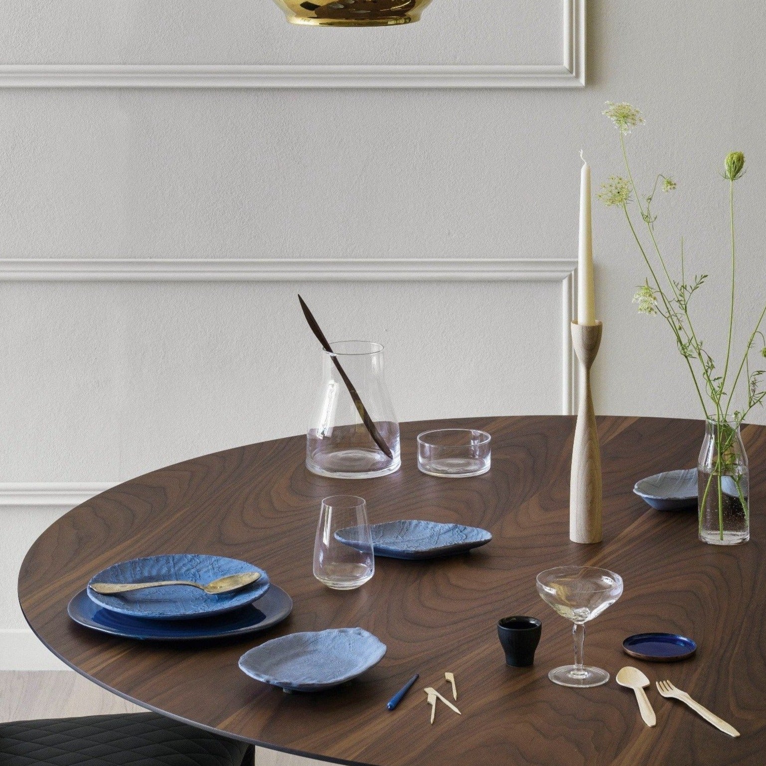 Round Walnut Acco Dining Table by Italian brand Miniforms with dishes