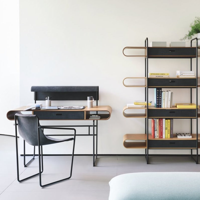 black Apelle leather armchair by Italian brand Midj near shelves