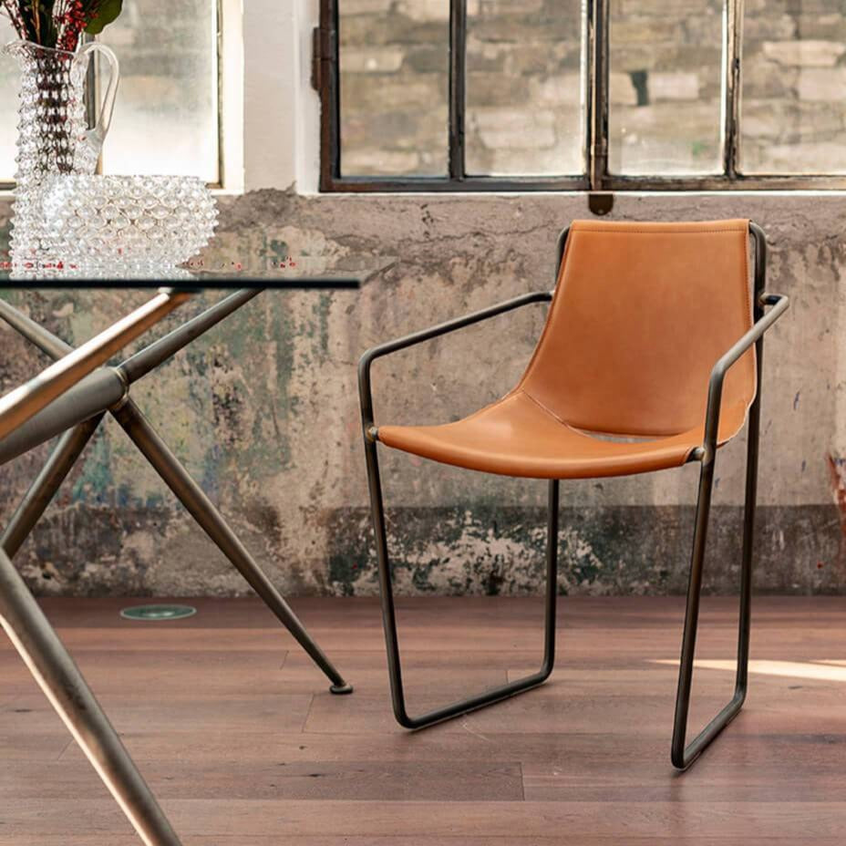 orange Apelle leather armchair by Italian brand Midj near a table