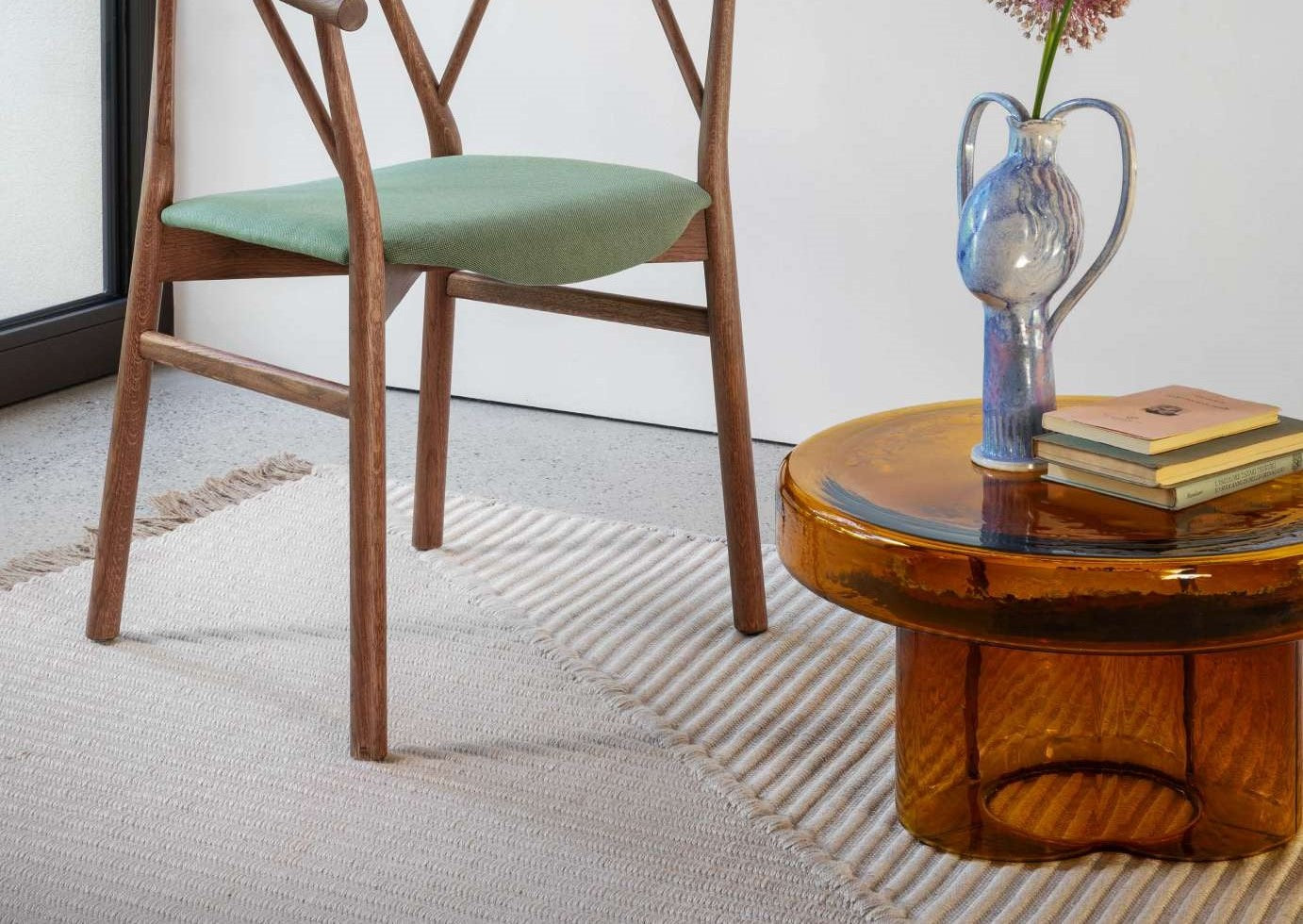 The Miniforms Soda Table in amber near an armchair
