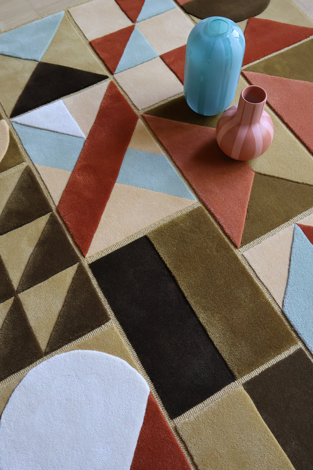 Geometric patterned rug with colorful geometric shapes on a checkered background