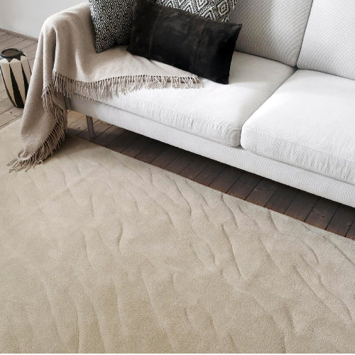 handmade modern area rug with sand texture near sofa