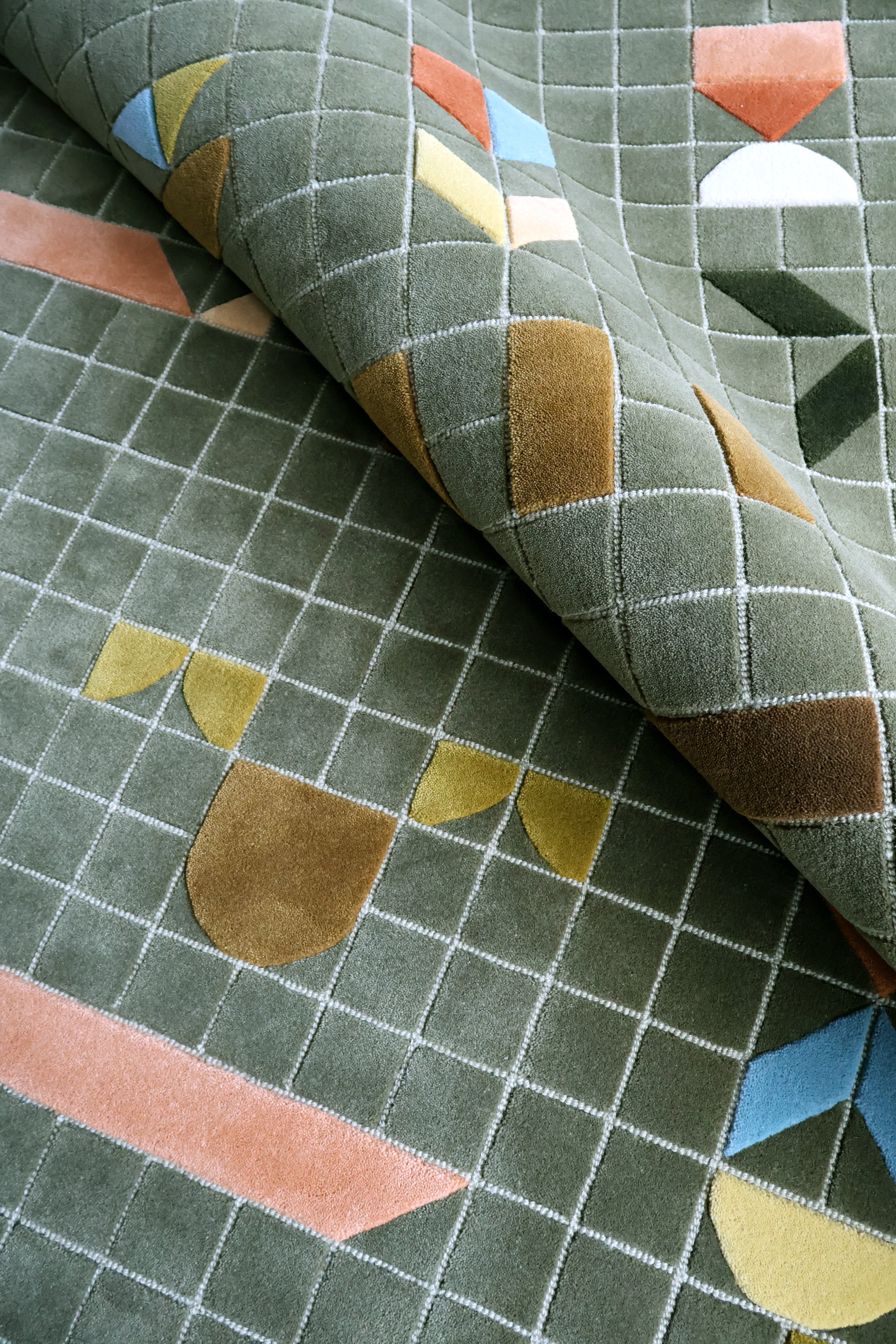Close-up of patterned fabric with geometric shapes on a green background