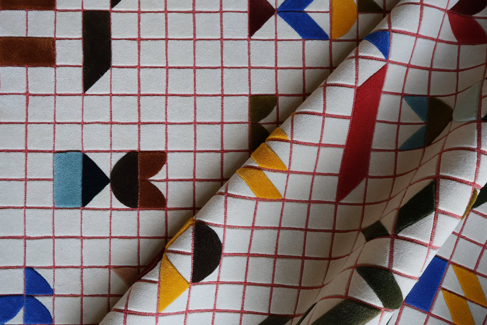 Close-up of patterned fabric with geometric shapes on a grid background