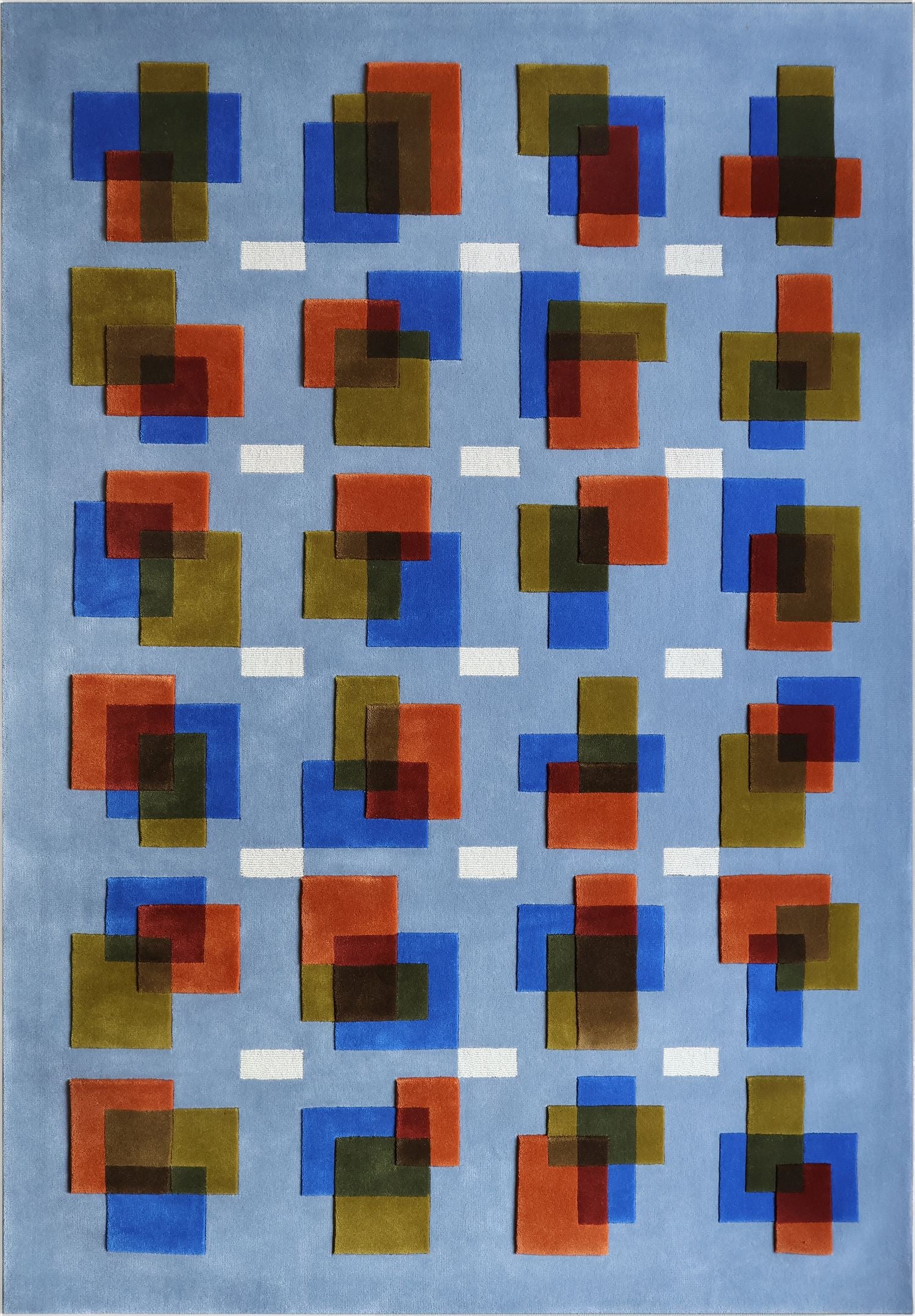 Rug with geometric pattern of squares in red, blue, and green on a light blue background