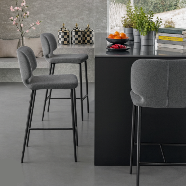 Modern kitchen with gray bar stools and a black island.